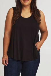 Model Ashleigh wearing size 16 of The Bamboo Crew Neck Swing Tank in colour Black (Black), from the front, cropped image
