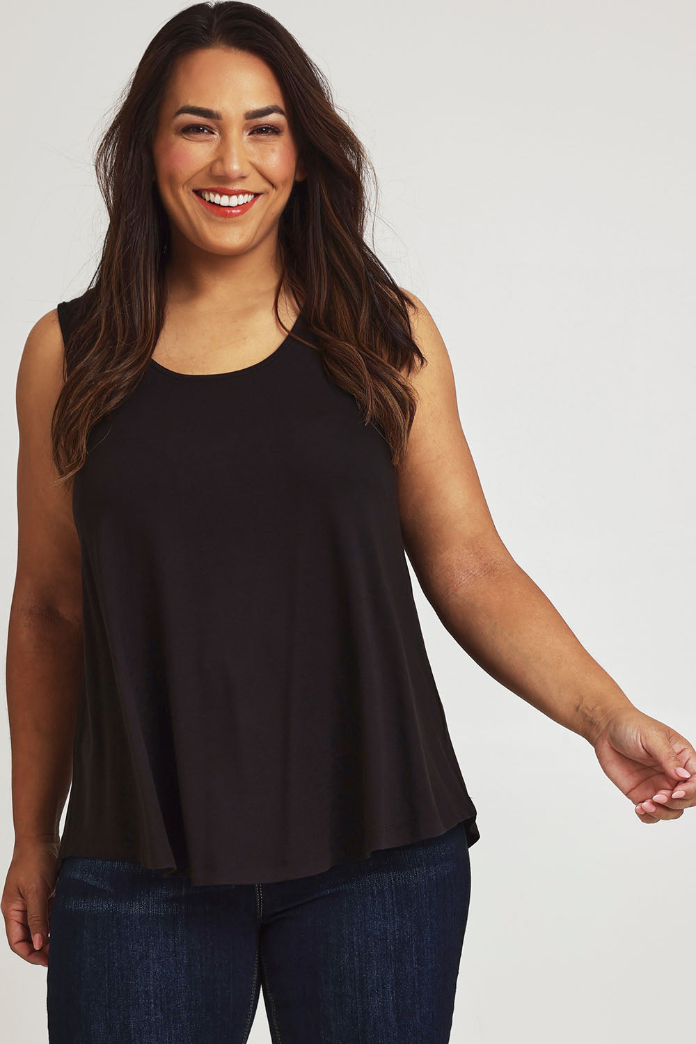 Model Ashleigh wearing size 16 of The Bamboo Crew Neck Swing Tank in colour Black (Black), from the front, cropped image