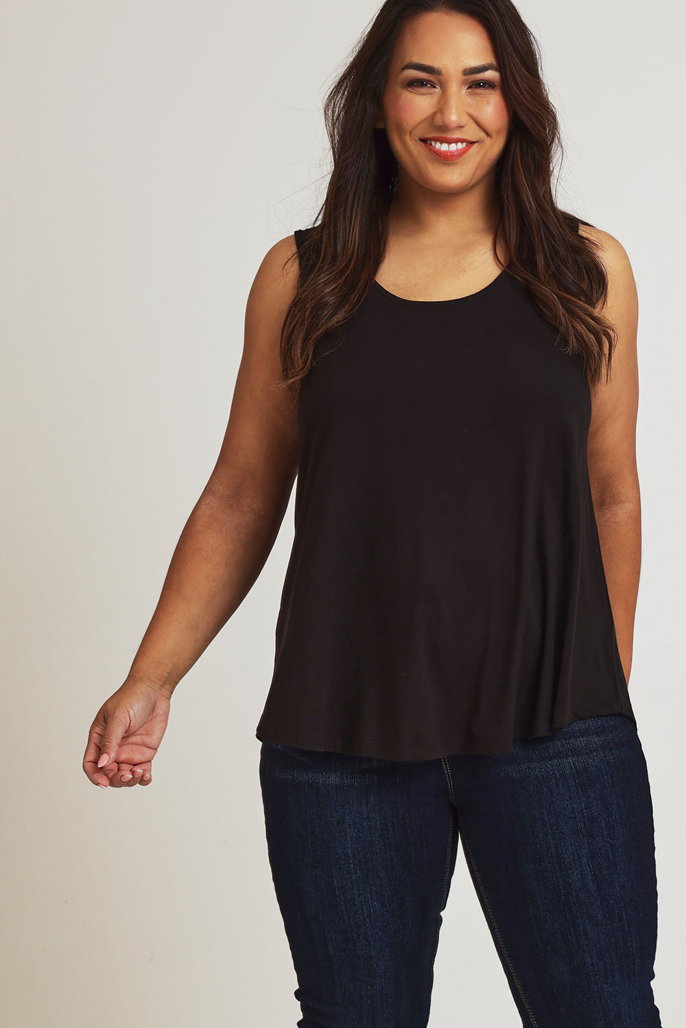 Model Ashleigh wearing size 16 of The Bamboo Crew Neck Swing Tank in colour Black (Black), from the front, showing the whole outfit
