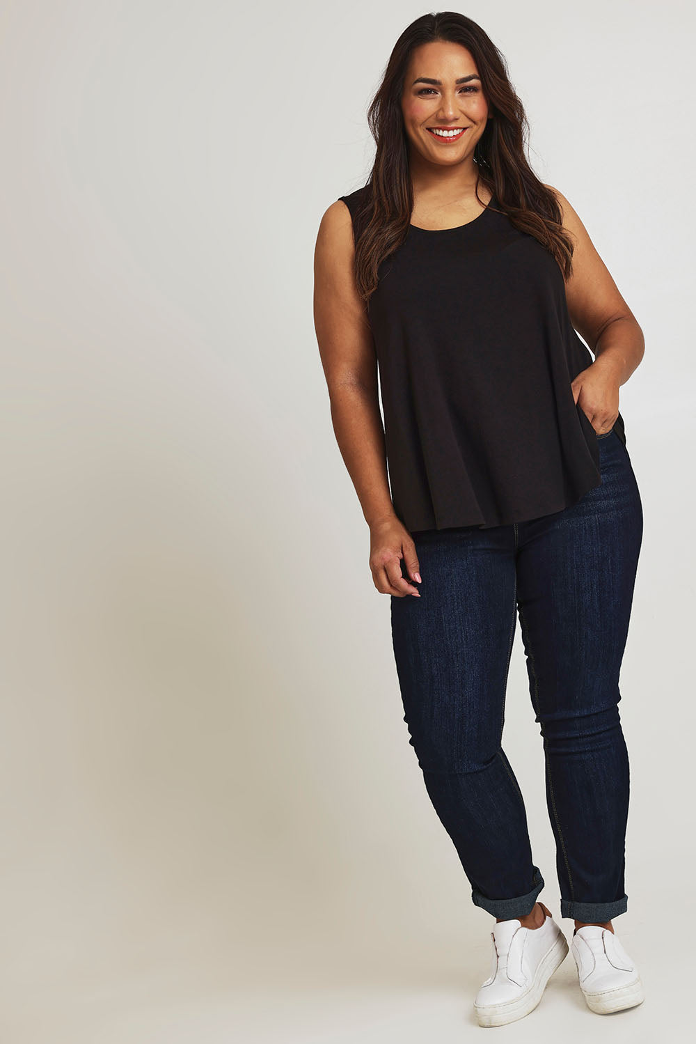 Model Ashleigh wearing size 16 of The Bamboo Crew Neck Swing Tank in colour Black (Black), from the front, showing the whole outfit
