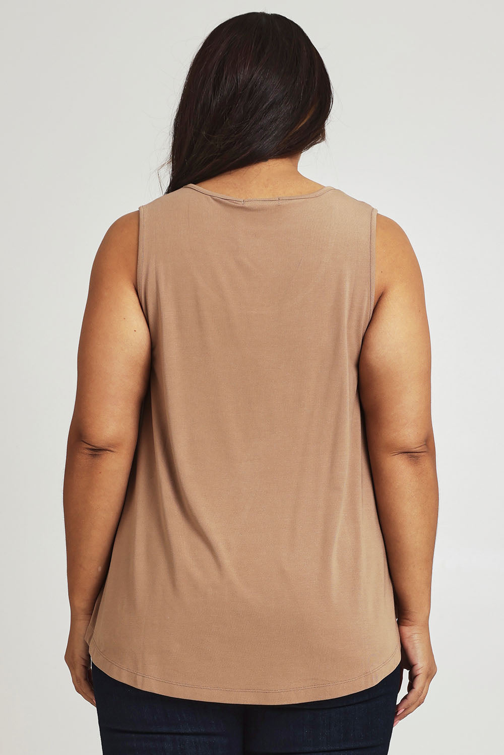 Model Ashleigh wearing size 16 of The Bamboo Crew Neck Swing Tank in colour Caramel, from the back