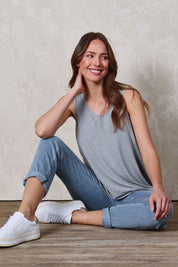 Model Madeline wearing size 10 of The Bamboo Crew Neck Swing Tank in colour Greymarle (Grey), from the front, showing the whole outfit