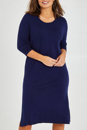 Model Monique wearing size L of The Transeasonal Crew Neck Dress in colour Boysenbery (Blue), from the front, cropped image