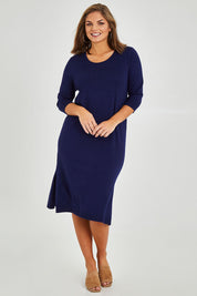 Model Monique wearing size L of The Transeasonal Crew Neck Dress in colour Boysenbery (Blue), from the front, showing the whole outfit