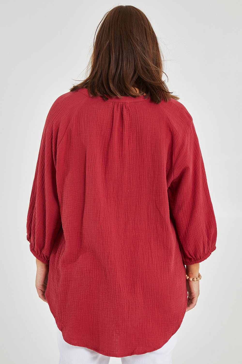 Model Monique wearing size 14 of The Cotton Crew Neck Shirt in colour Chillired (Red), from the back