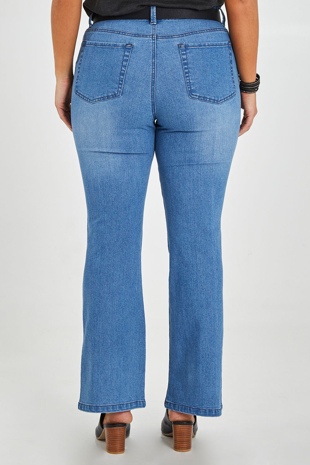 Model Monique wearing size 14 of The Contour Bootleg Jean in colour Lightdenim (Blue), from the back