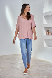 Model Amanda wearing size S of The Relaxed V Neck Knit Tee in colour Blushcandy (Pink), from the front, showing the whole outfit