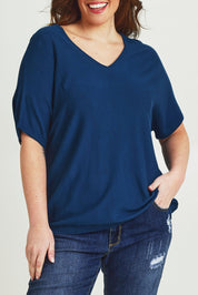 Model Jane wearing size L of The Relaxed V Neck Knit Tee in colour Petrol (Blue), from the front, cropped image