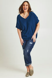 Model Jane wearing size L of The Relaxed V Neck Knit Tee in colour Petrol (Blue), from the front, showing the whole outfit