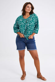 Model Monique wearing size 14 of The Keepers Crew Neck Printed Shirt in colour Tealwhite (Green), from the front, showing the whole outfit