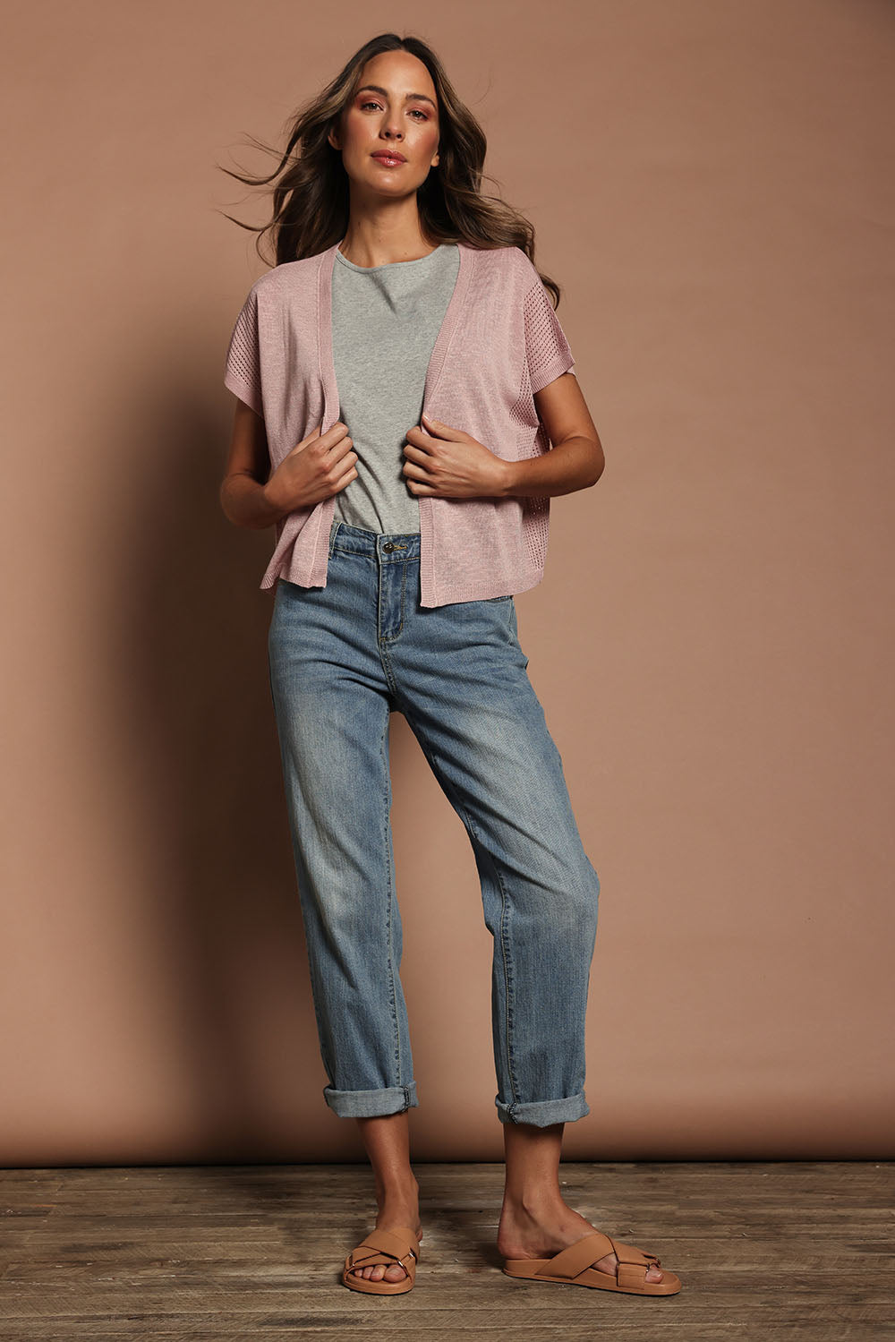 Model Madeline wearing size S of The Short Sleeve Shrug in colour Blushpink (Pink), from the front, showing the whole outfit