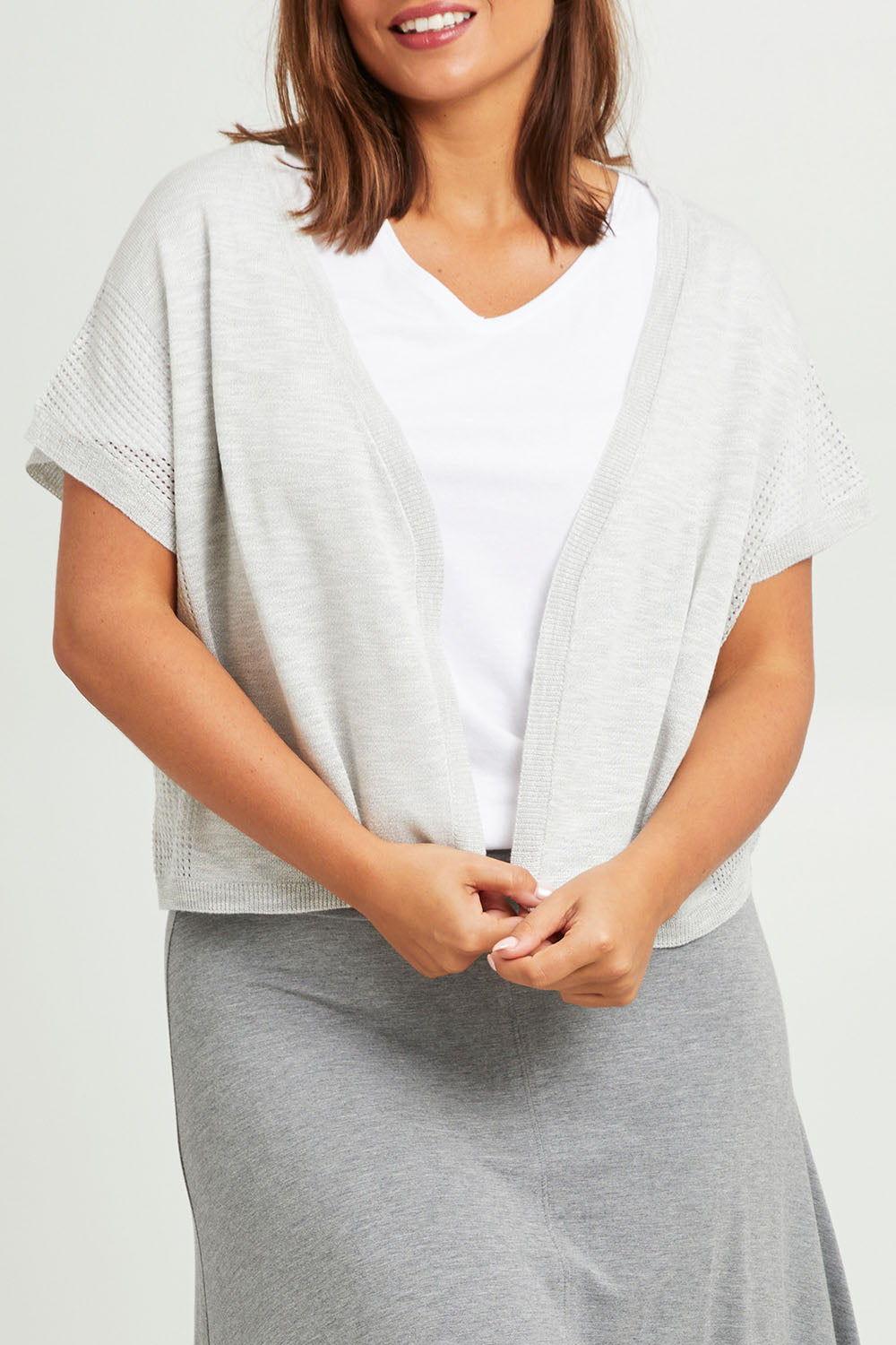 Model Monique wearing size L of The Short Sleeve Shrug in colour Greymarle (Grey), from the front, cropped image
