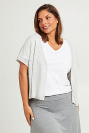 Model Monique wearing size L of The Short Sleeve Shrug in colour Greymarle (Grey), from the front, cropped image