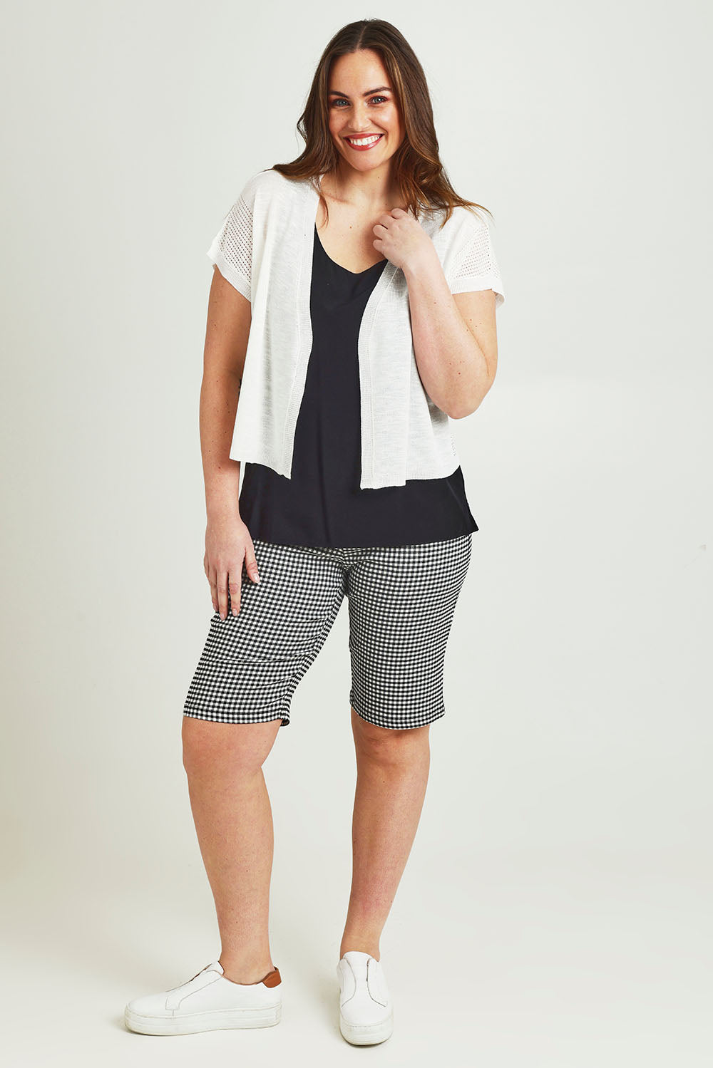 Model Jane wearing size L of The Short Sleeve Shrug in colour White (White), from the front, showing the whole outfit