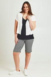 Model Jane wearing size L of The Short Sleeve Shrug in colour White (White), from the front, showing the whole outfit