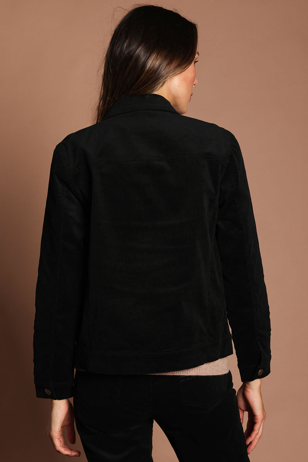 Model Madeline wearing size 10 of The Keepers Cord Jacket in colour Black (Black), from the back