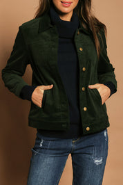 Model Madeline wearing size 10 of The Keepers Cord Jacket in colour Deepforest (Green), from the front, cropped image