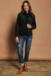Model Madeline wearing size 10 of The Keepers Cord Jacket in colour Deepforest (Green), from the front, showing the whole outfit