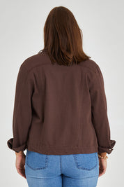 Model Monique wearing size 14 of The Slim Fit Denim Jacket in colour Chocolate, from the back