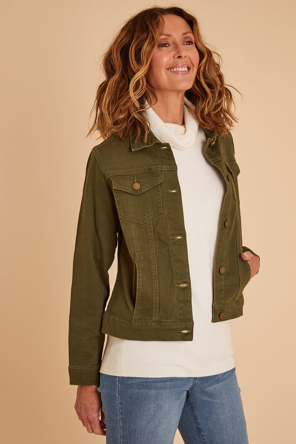 Model Emma wearing size 10 of The Slim Fit Denim Jacket in colour Khaki (Green), from the front, cropped image