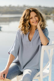 Model Emma wearing size 10 of The Double Cotton Collar Top in colour Chambray (Blue), from the front, showing the whole outfit