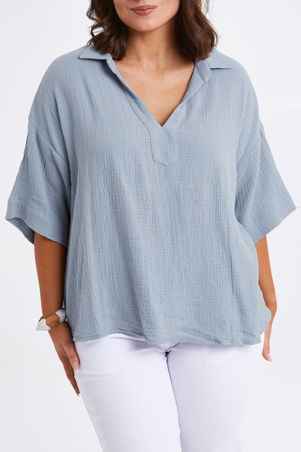 Model Monique wearing size 14 of The Double Cotton Collar Top in colour Chambray (Blue), from the front, cropped image