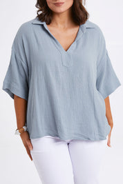 Model Monique wearing size 14 of The Double Cotton Collar Top in colour Chambray (Blue), from the front, cropped image