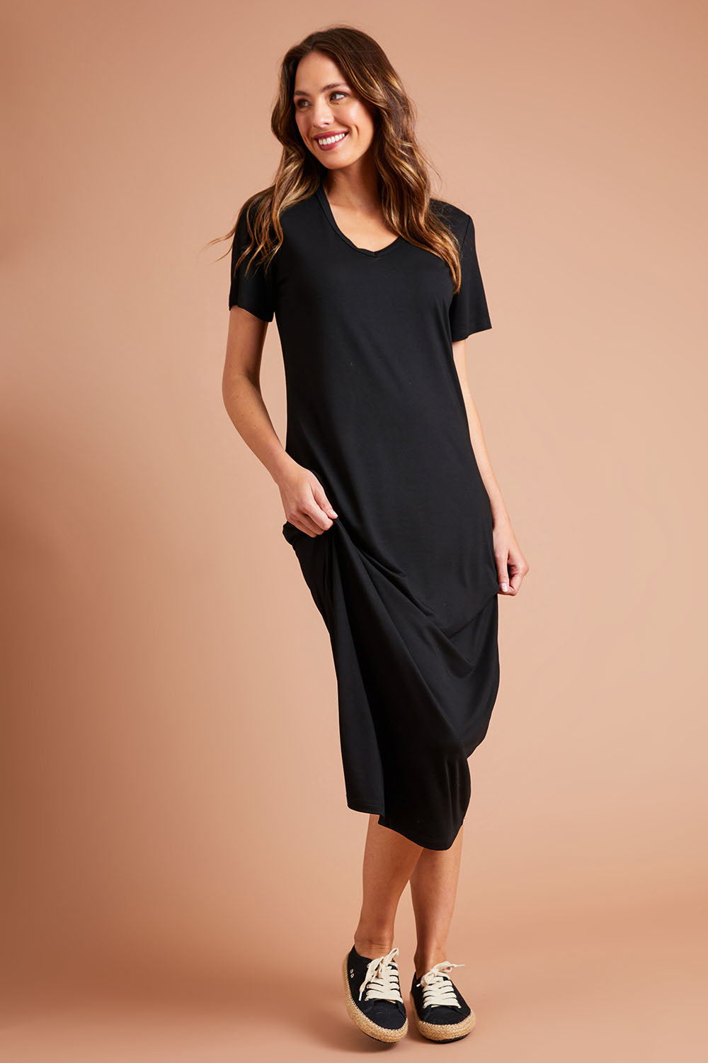 Model Madeline wearing size 10 of The V Neck Bamboo Maxi Dress in colour Black (Black), from the front, showing the whole outfit