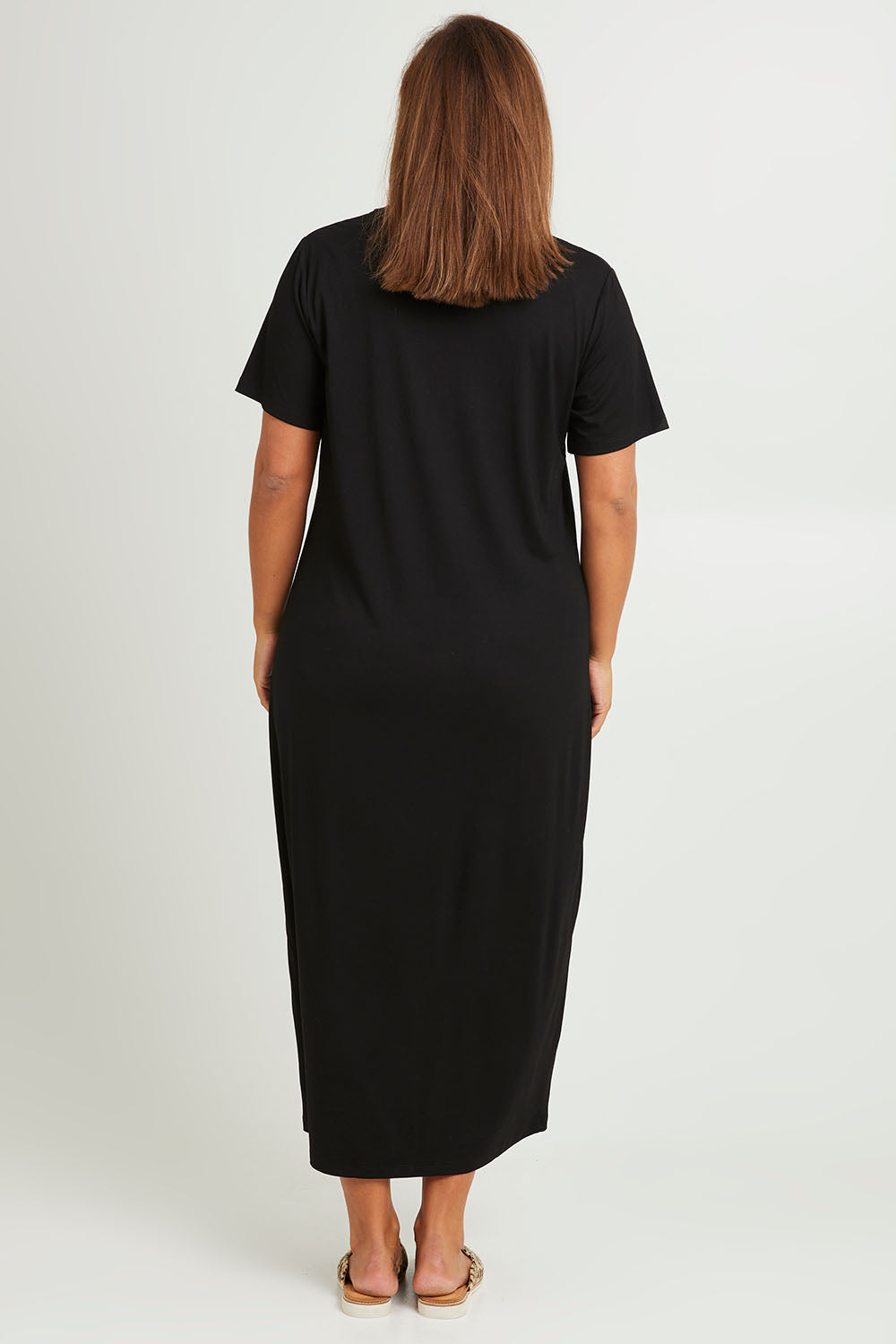 Model Monique wearing size 14 of The V Neck Bamboo Maxi Dress in colour Black (Black), from the back