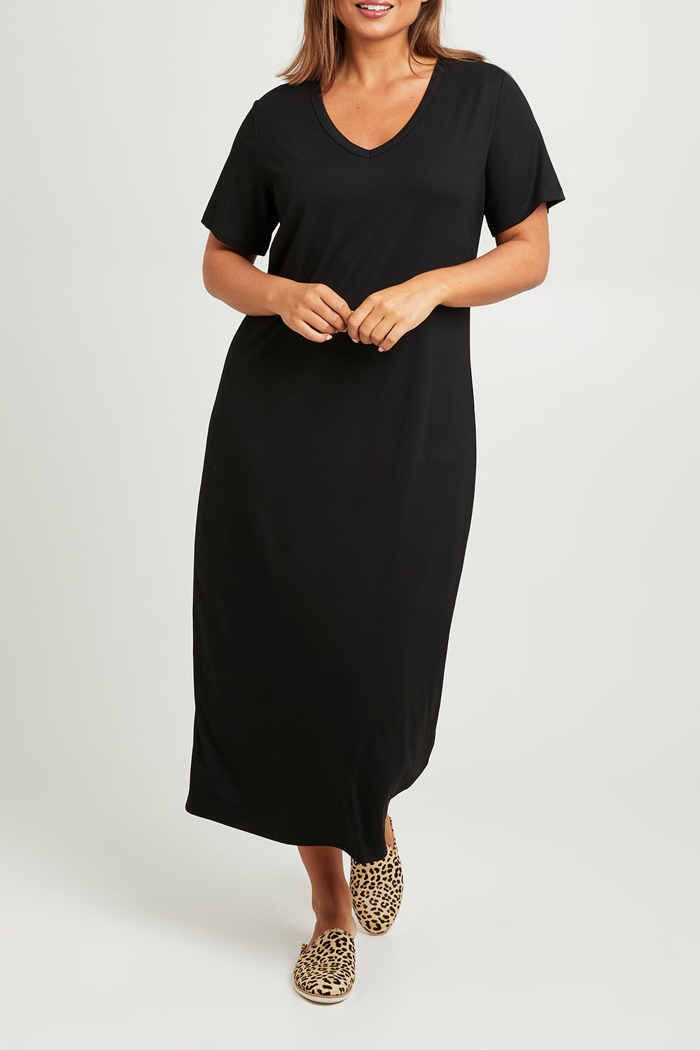 Model Monique wearing size 14 of The V Neck Bamboo Maxi Dress in colour Black (Black), from the front, cropped image