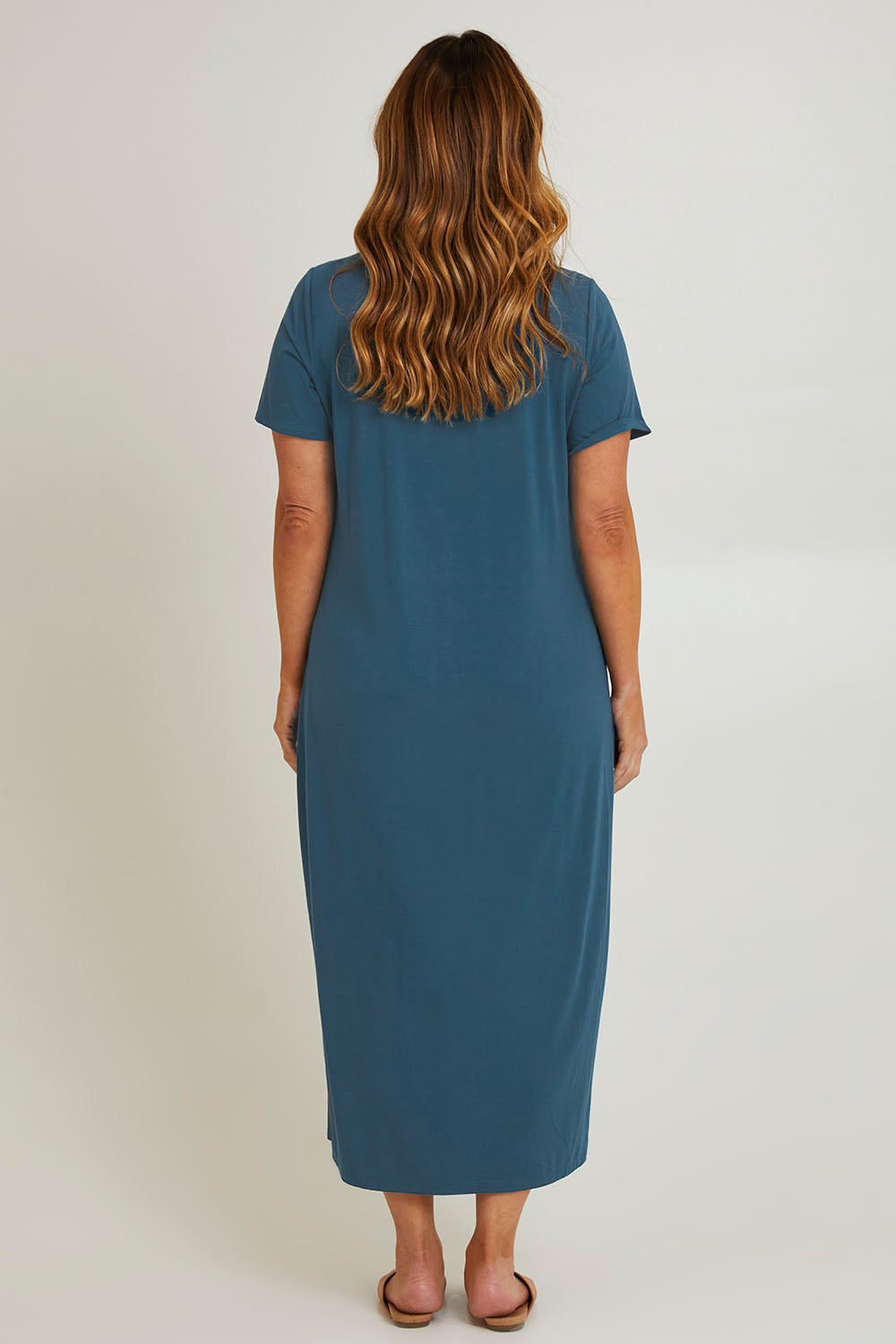 Model Laura wearing size 14 of The V Neck Bamboo Maxi Dress in colour Oceanblue (Blue), from the back