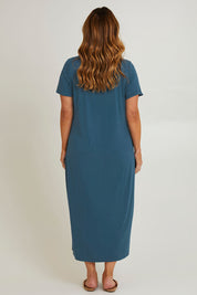 Model Laura wearing size 14 of The V Neck Bamboo Maxi Dress in colour Oceanblue (Blue), from the back