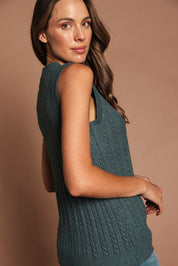 Model Madeline wearing size S of The Soft Sleeveless Cable Knit Jumper in colour Bluegrass (Blue), from the front, cropped image