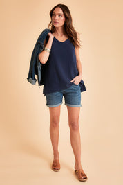 Model Madeline wearing size 10 of The Double Cotton V Tank in colour Navy (Blue), from the front, showing the whole outfit