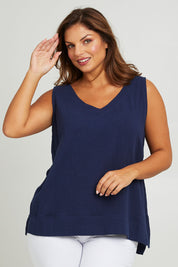 Model Monique wearing size 14 of The Double Cotton V Tank in colour Navy (Blue), from the front, cropped image