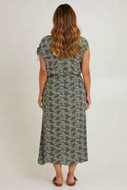 Model Laura wearing size 14 of The Drawstring Printed Maxi Dress in colour Fernfloral (Green), from the back