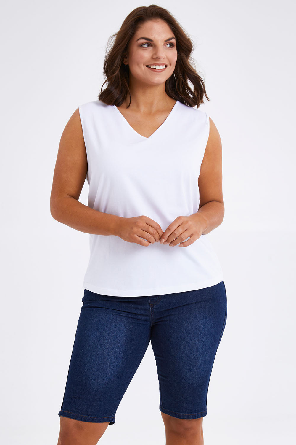 Model Monique wearing size 14 of The Pull On Denim Short in colour Darkdenim (Blue), from the front, cropped image