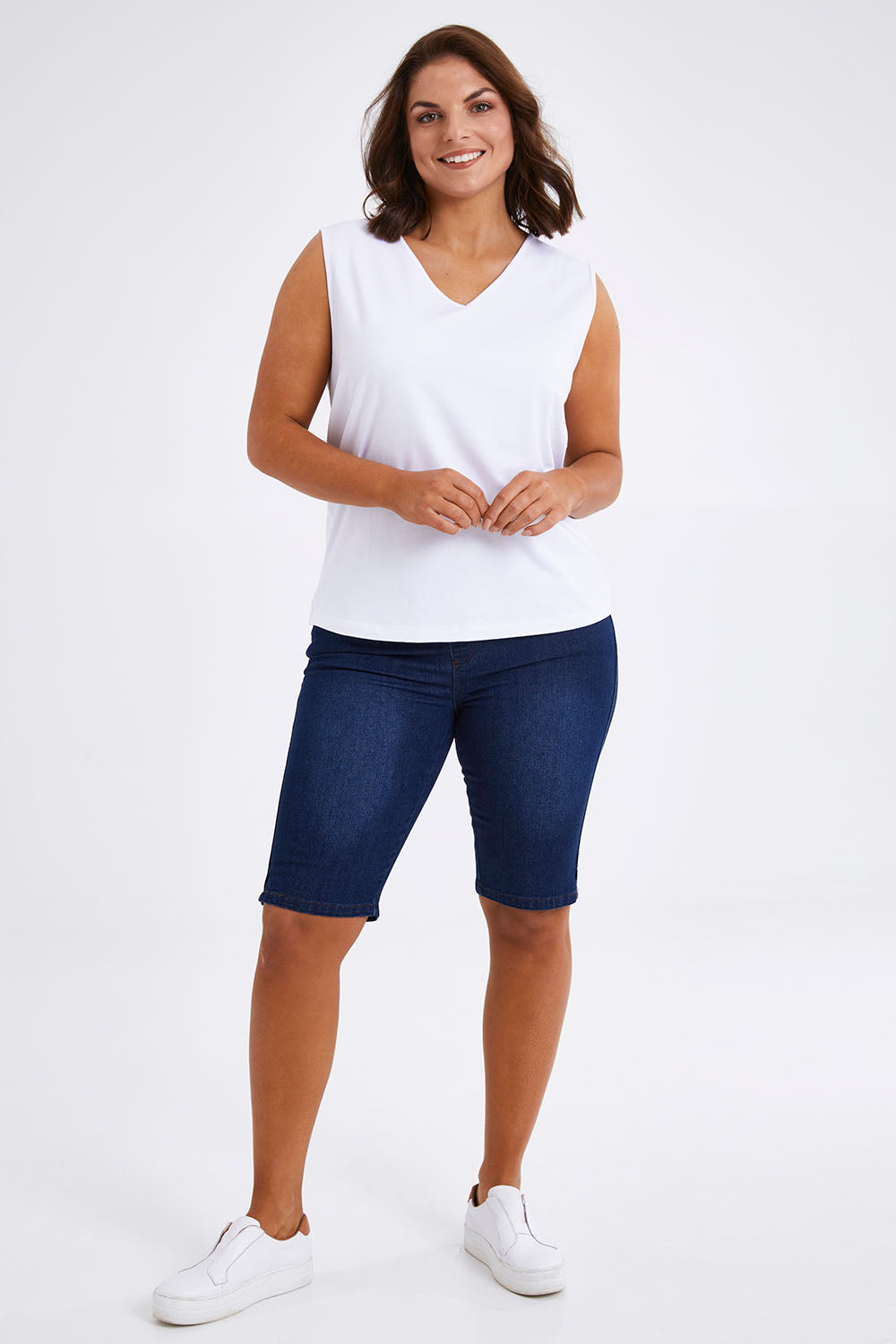 Model Monique wearing size 14 of The Pull On Denim Short in colour Darkdenim (Blue), from the front, showing the whole outfit