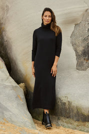 Model Amanda wearing size S of The Roll Neck Knit Maxi Dress in colour Black (Black), from the front, showing the whole outfit