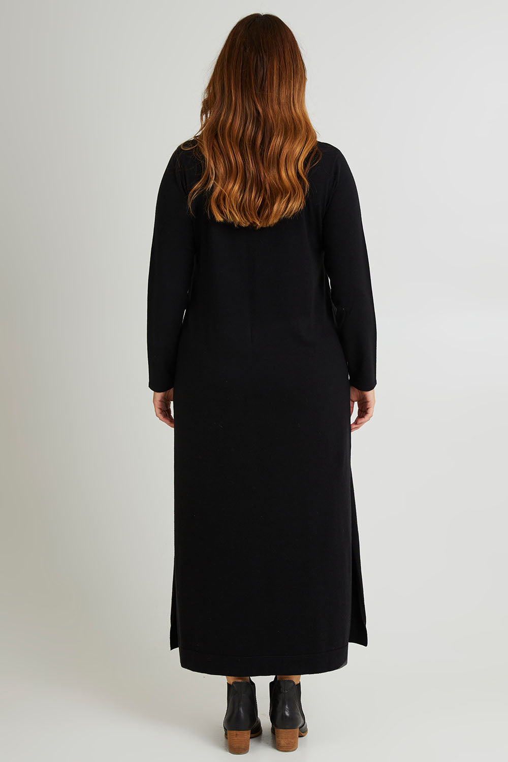 Model Laura wearing size L of The Roll Neck Knit Maxi Dress in colour Black (Black), from the back