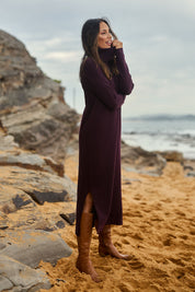 Model Amanda wearing size S of The Roll Neck Knit Maxi Dress in colour Burntplum (Purple), from the front, showing the whole outfit