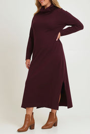 Model Chanel wearing size XL of The Roll Neck Knit Maxi Dress in colour Burntplum (Purple), from the front, cropped image