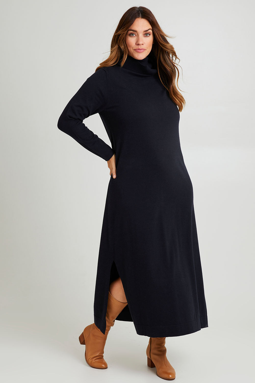 Model Laura wearing size L of The Roll Neck Knit Maxi Dress in colour Darknavy (Blue), from the front, showing the whole outfit