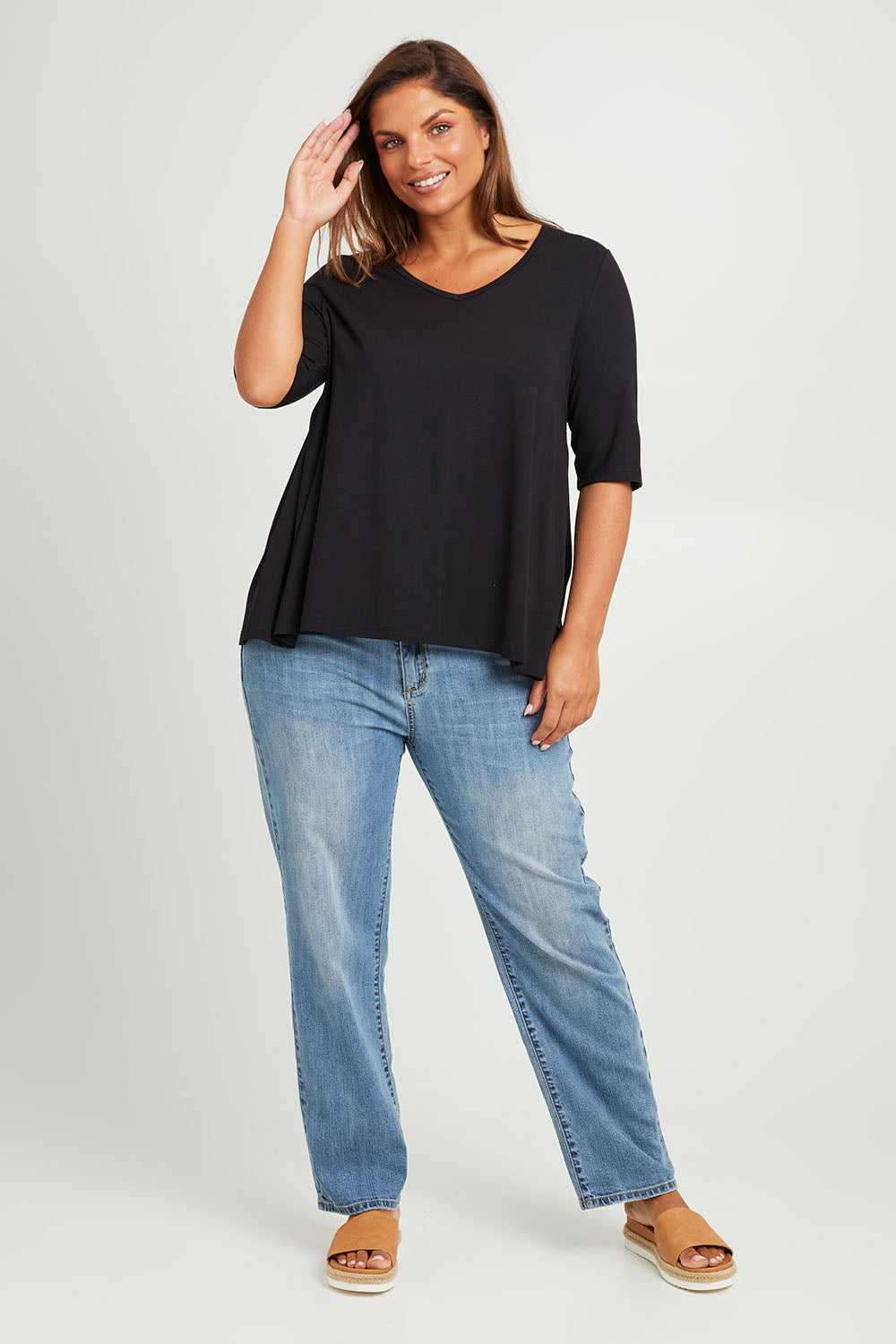 Model Monique wearing size 14 of The Luxe A Line Tee in colour Black (Black), from the front, showing the whole outfit