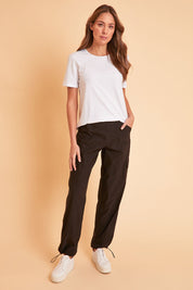 Model Madeline wearing size 10 of The Everyday Full Length Cargo Pant in colour Black (Black), from the front, showing the whole outfit