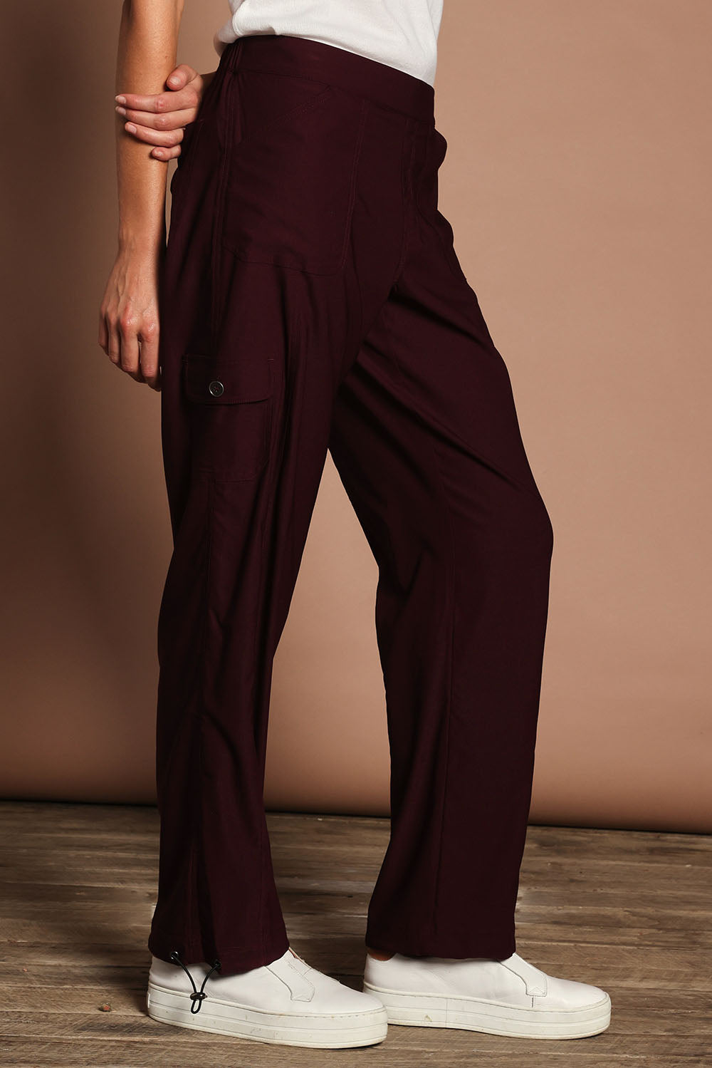 Model Madeline wearing size 10 of The Everyday Full Length Cargo Pant in colour Claret (Red), from the front, cropped image