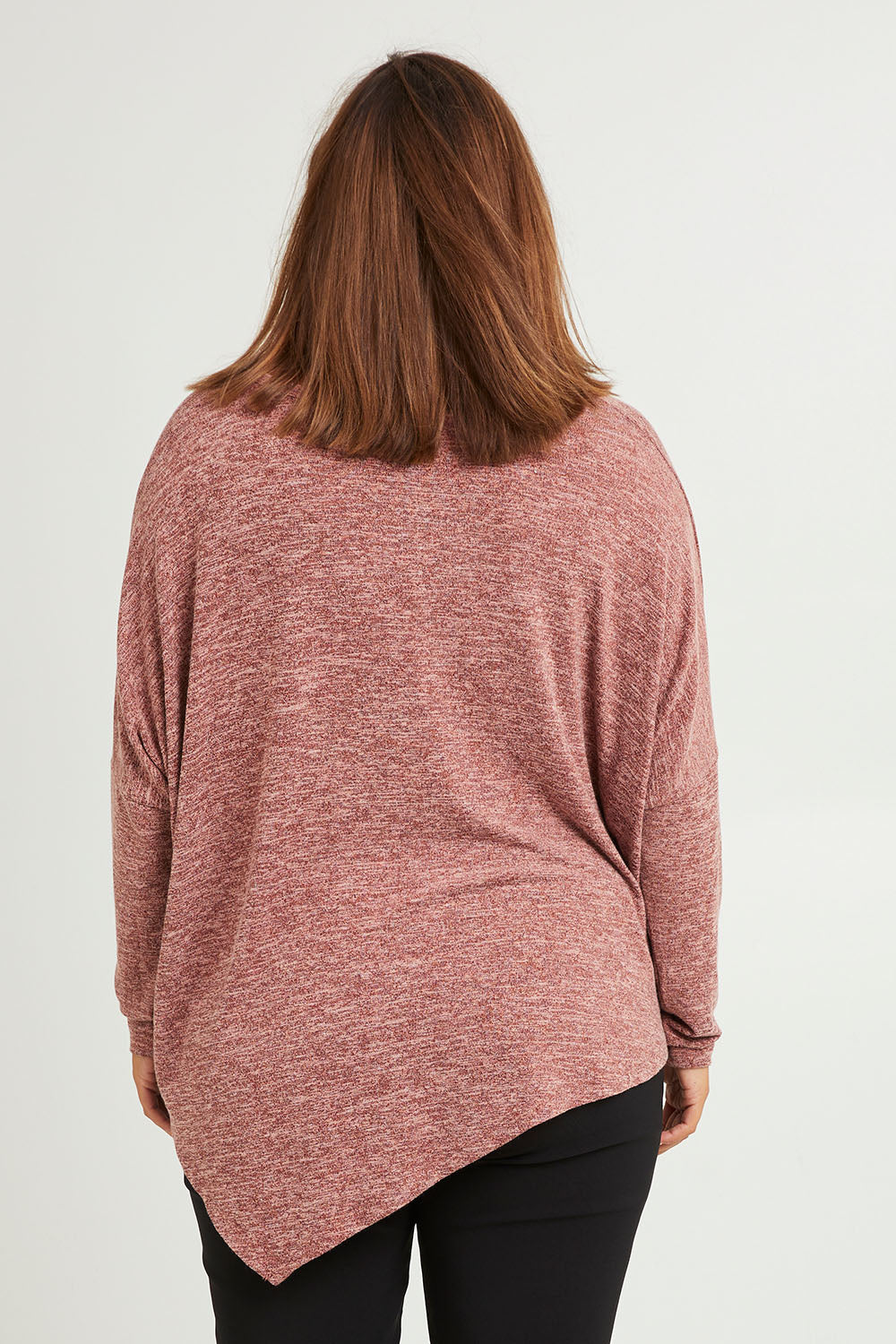 Model Monique wearing size 14 of The Asymmetric Soft Knit Tee in colour Terracotta, from the back