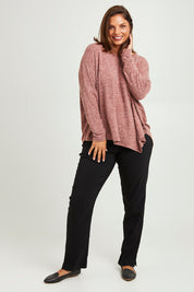 Model Monique wearing size 14 of The Asymmetric Soft Knit Tee in colour Terracotta, from the front, showing the whole outfit