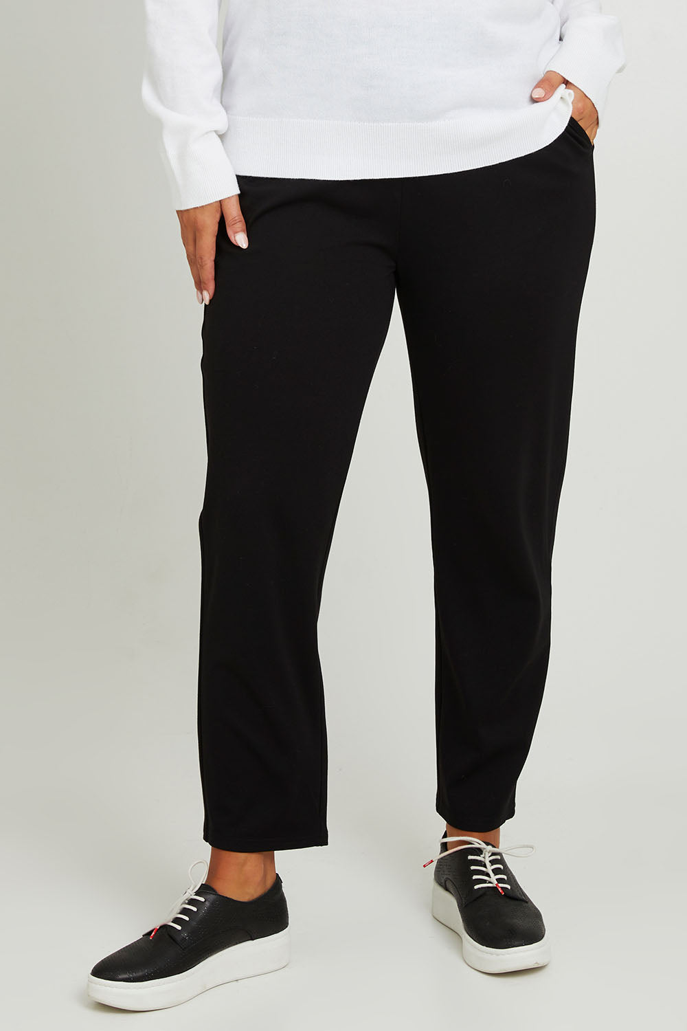 Model Monique wearing size 14 of The Easy Wear Ponte Pant in colour Black (Black), from the front, cropped image
