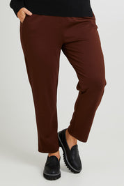Model Laura wearing size 14 of The Easy Wear Ponte Pant in colour Chocolate, from the front, cropped image